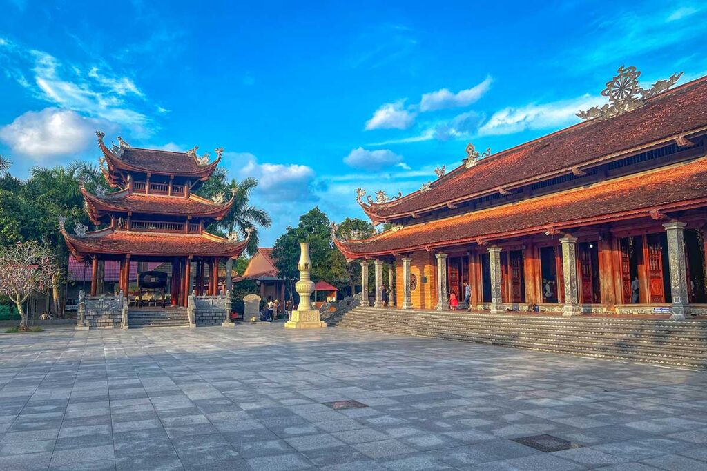 Courtyard view of Truc Lam Phuong Nam Zen Monastery in Can Tho with the bell tower and main hall side by side.