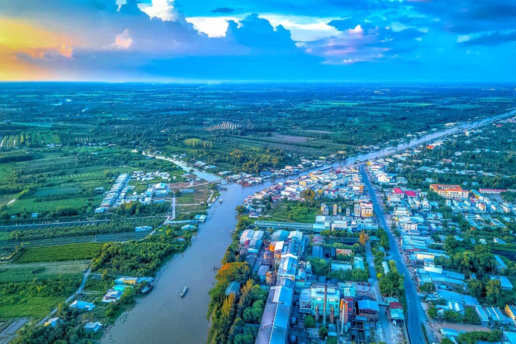 Aerial view of Vi Thanh City, Hau Giang Province, Vietnam – panoramic photo showing rivers, canals, and green countryside around the provincial capital at sunset.