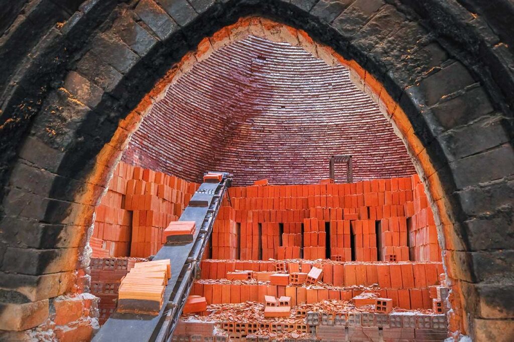 Interior of a traditional kiln stacked with red bricks in Mang Thit, Vinh Long