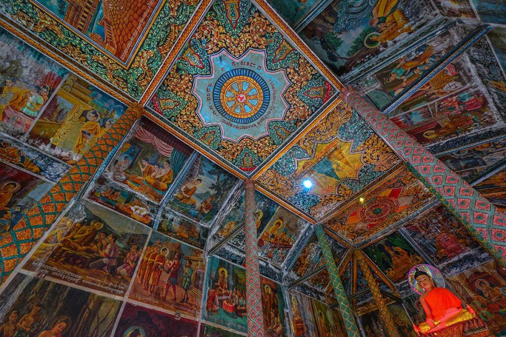 The murals on the walls and roof of the interior inside the Xiem Can Pagoda main hall