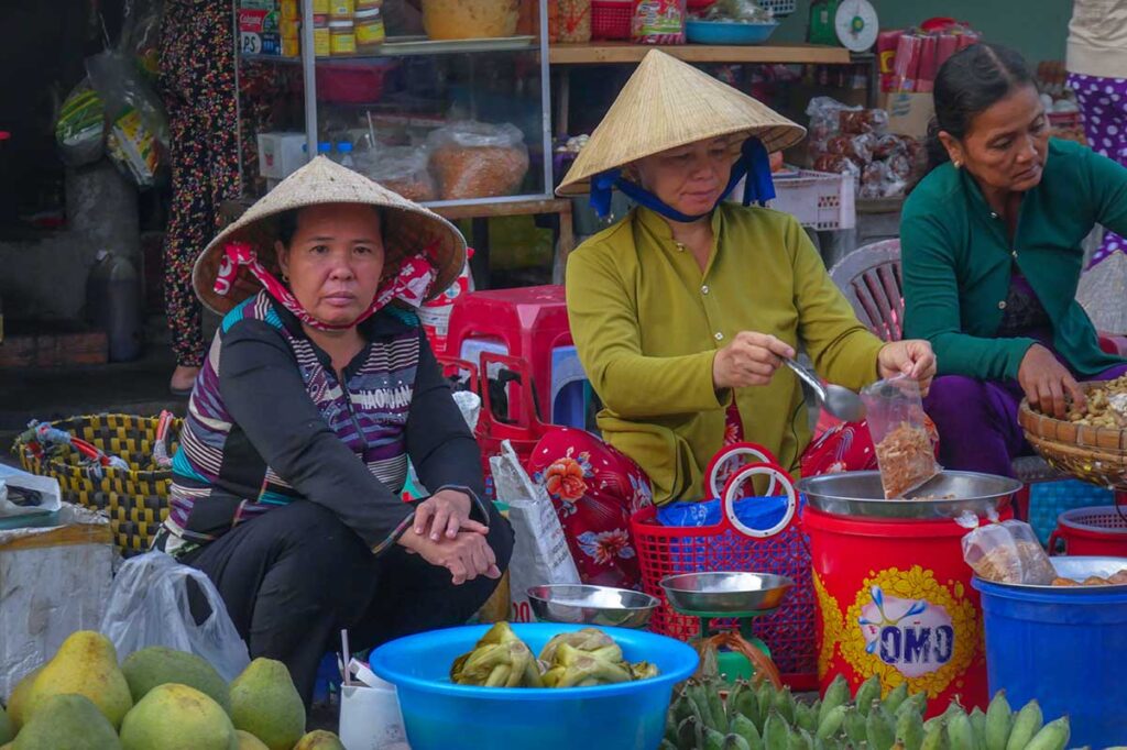 Meat and fruit stall at An Binh Market in Can Tho with a woman vendor and local produce