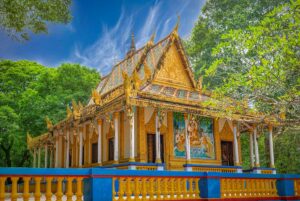 Main worship hall of Bat Pagoda (Chùa Dơi) in Soc Trang with colorful Khmer decorations, murals, and golden reliefs.