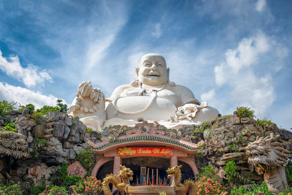 Close-up of Maitreya Buddha statue – Giant Maitreya Buddha on Cam Mountain, the largest of its kind in Southeast Asia, with detailed carvings and shrines.