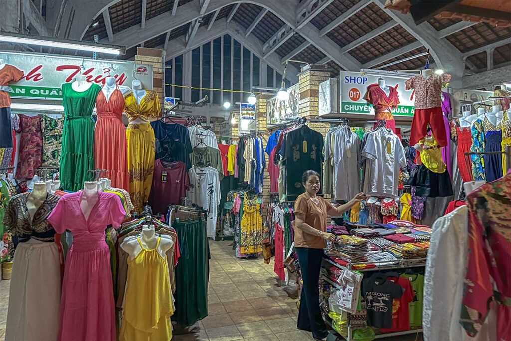 Indoor clothing stalls at Can Tho Old Market with dresses, shirts, and local fashion