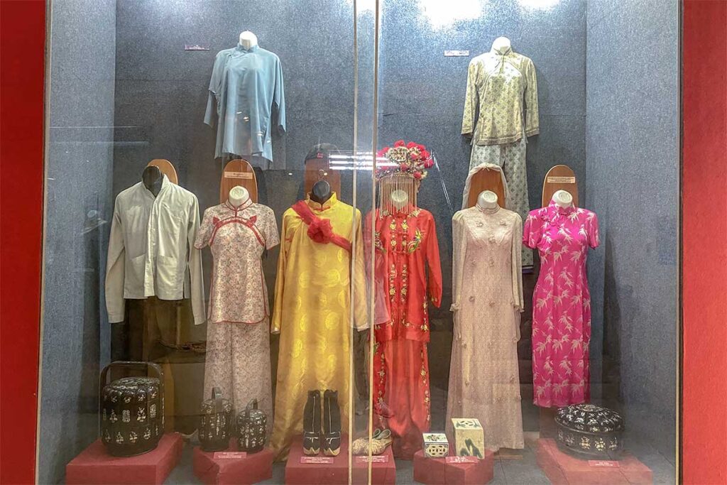 Exhibition of traditional Vietnamese, Khmer, and Chinese clothing at Can Tho Museum, including ceremonial and daily wear.