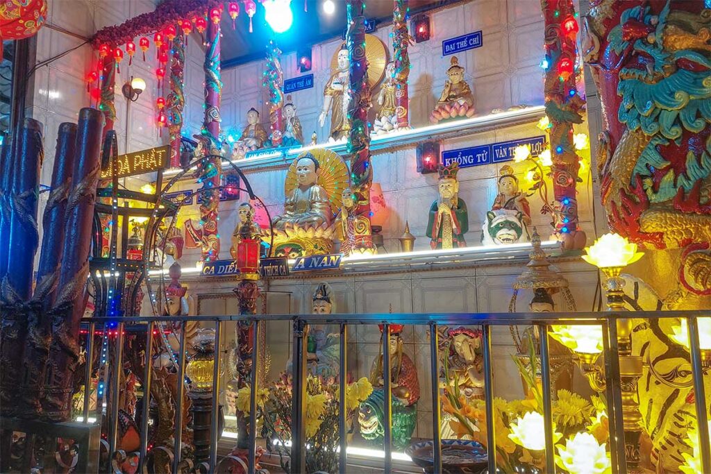 Clay Pagoda interior with rows of clay statues – Shelves filled with hand-sculpted clay Buddhas and deities lit by colorful lights inside the main hall.
