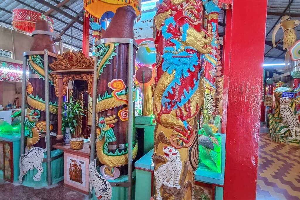 Clay Pagoda Chùa Đất Sét giant candles and dragon pillars – Colorful clay dragons and tigers wrapped around pillars beside the famous giant candles inside the pagoda in Soc Trang.