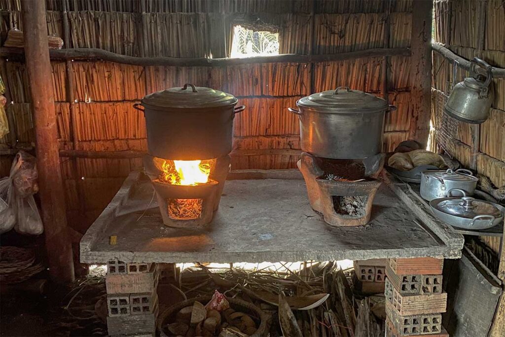 Traditional Vietnamese kitchen with clay stoves and large cooking pots on Con Chim Island in Tra Vinh province