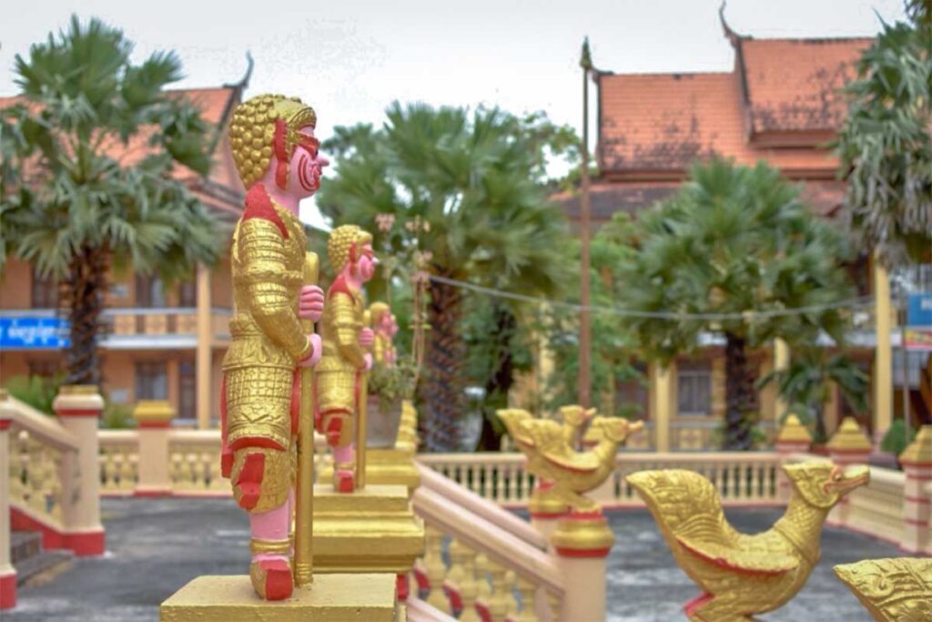 Golden guardian statues at Kh’leang Pagoda in Soc Trang, part of the Khmer architectural details surrounding the temple.