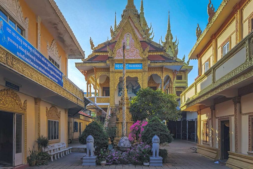 Front view of Muniransay Khmer Buddhist Temple in Can Tho with ornate golden façade and Khmer-style roof
