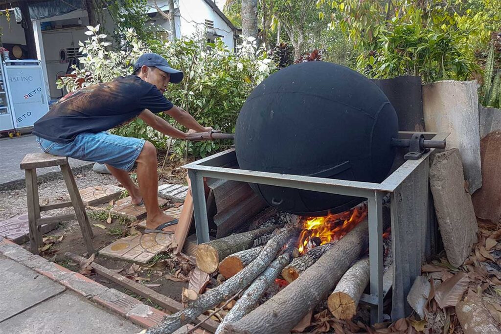 raditional cacao roasting over a wood fire at Muoi Cuong Cacao Farm in Can Tho