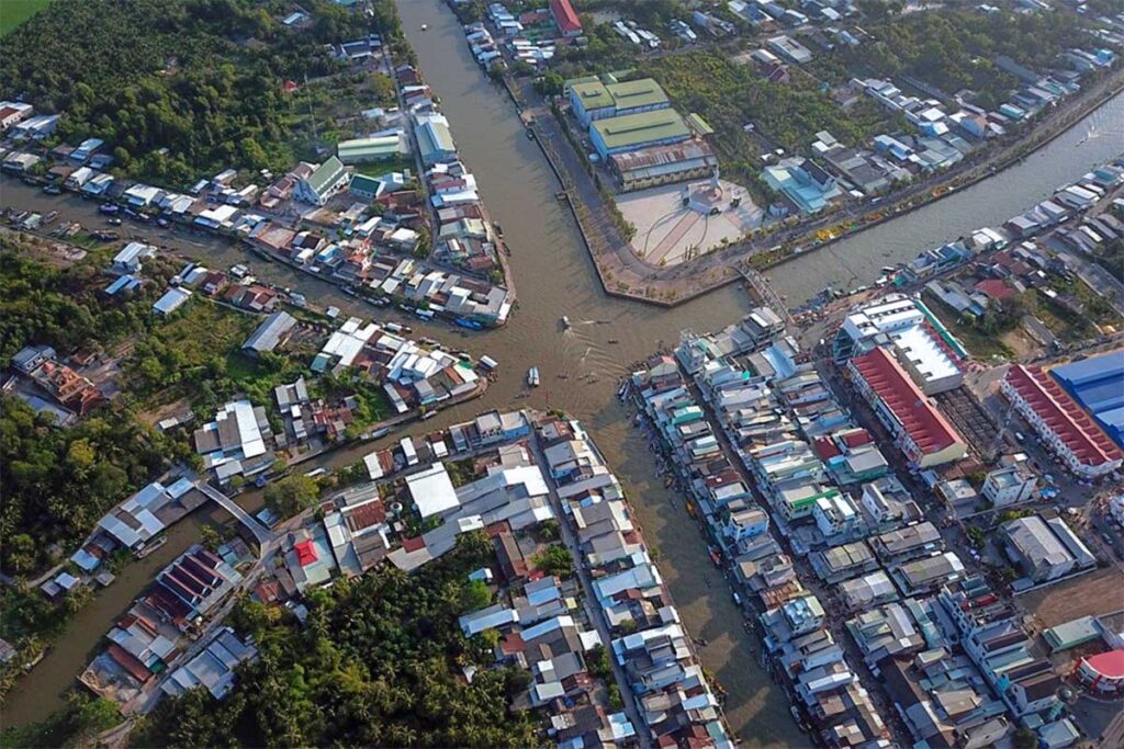Aerial view of Nga Nam’s five-way canal junction surrounded by town streets and houses in Soc Trang, Vietnam.