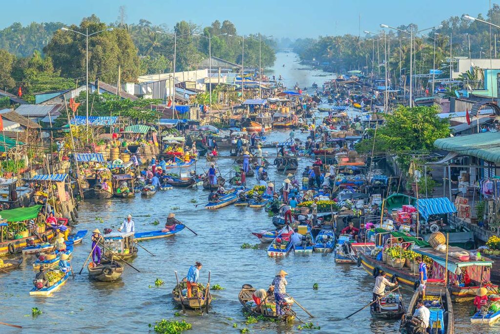 Colorful boats packed with fruits and vegetables crowding Nga Nam Floating Market in Soc Trang Province, Mekong Delta.