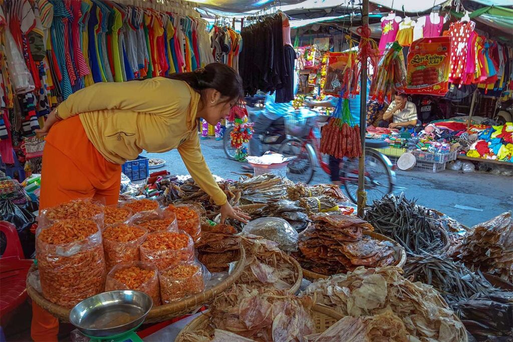 Local woman selling dried shrimp and seafood products at Nga Nam market.