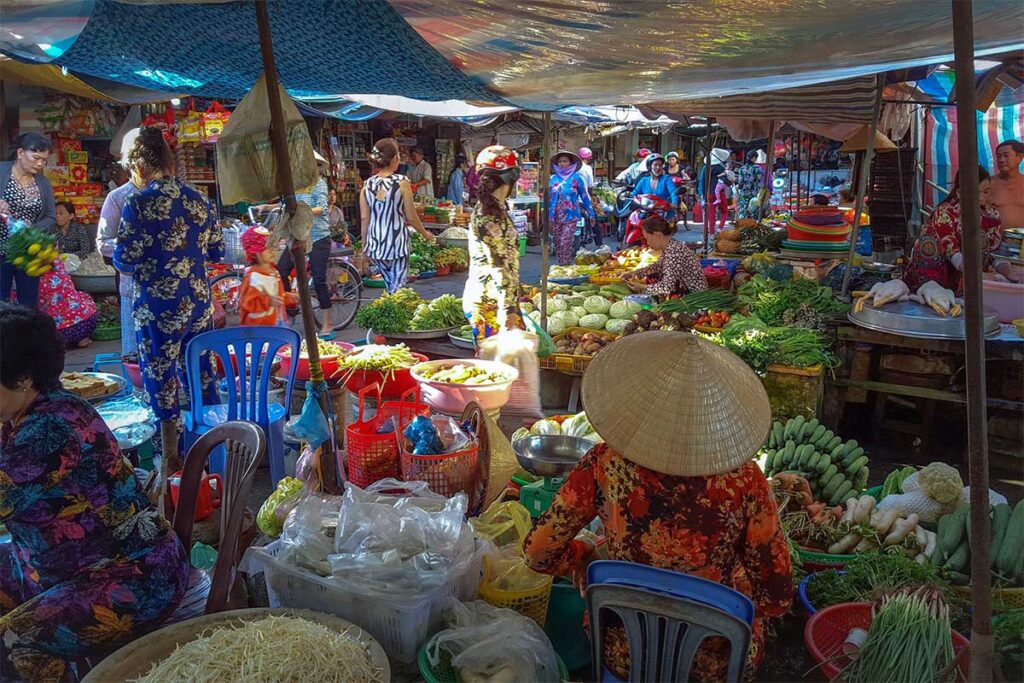 Bustling vegetable and produce stalls inside Nga Nam Land Market.