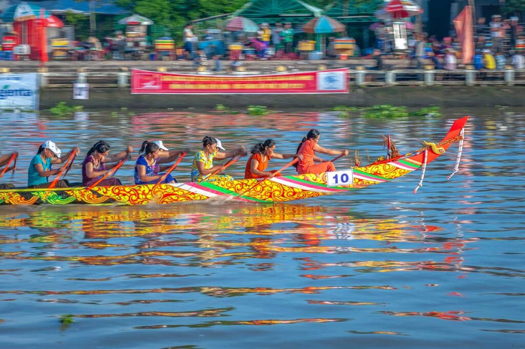 Women’s team paddling a traditional Khmer longboat during the Ghe Ngo Boat Race Festival in Soc Trang, part of the Ok Om Bok celebrations.