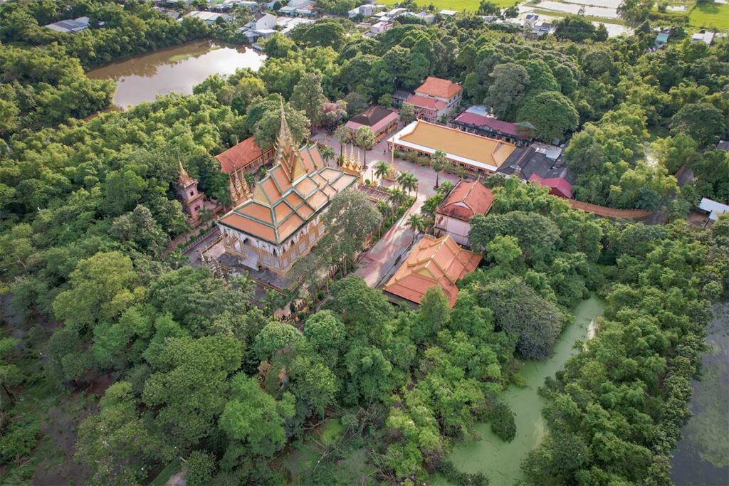 Aerial view of Nodol Pagoda (Stork Temple) in Tra Vinh, showing the main hall, stupas, and surrounding green forest