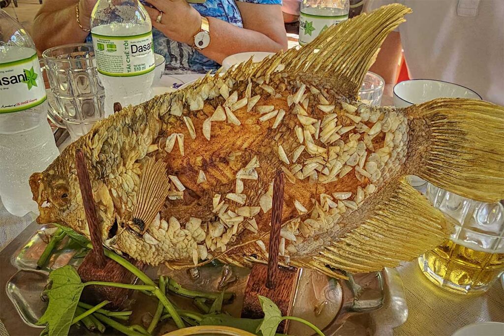 Crispy fried elephant ear fish served upright at Ong Kiet’s Ancient House restaurant in Cai Be, Tien Giang – a signature Mekong Delta dish often included in local set menus.