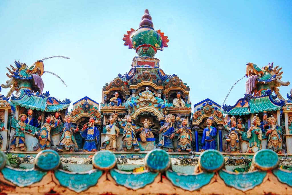 Colorful rooftop statues of deities and mythical figures at Ong Pagoda Can Tho