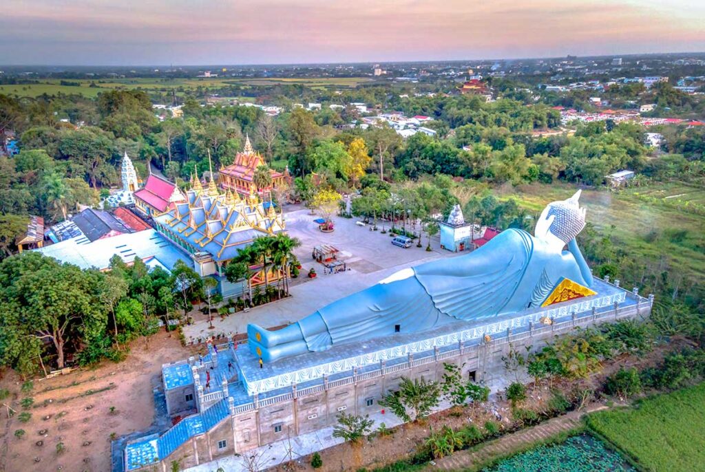 Aerial view of Som Rong Pagoda with the 63-meter reclining Buddha statue in Soc Trang, Vietnam, surrounded by Khmer temple halls and greenery