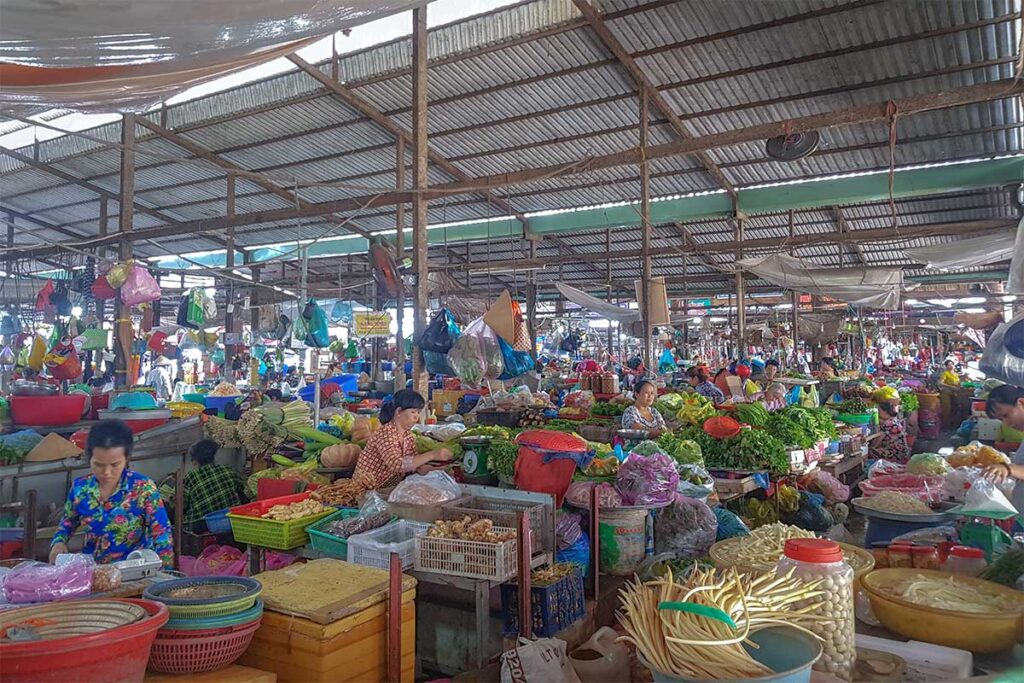Local sellers with stalls full of vegetables and fruits on Tan An Market in Can Tho