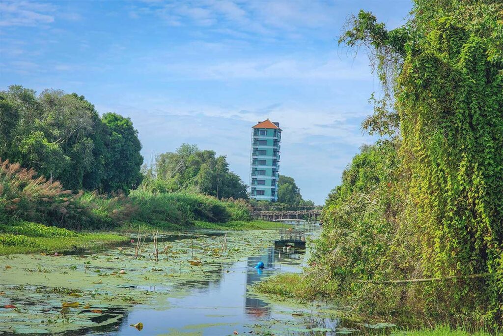 Tan Lap tower hotel beside canal and lotus wetland in Long An, Vietnam