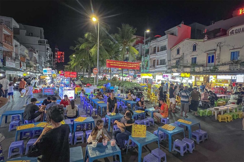 Crowded Tay Do Night Market with street food stalls and plastic tables near Can Tho Market