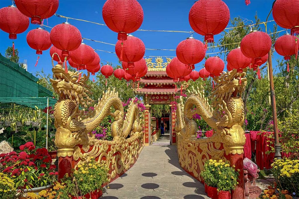 Dragon archway decorated with red lanterns during festival at Van Phuoc Pagoda, Ben Tre