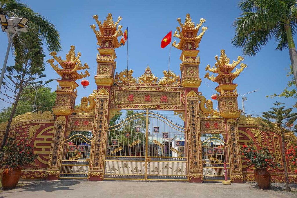 Golden three-entrance Tam Quan Gate at Van Phuoc Pagoda in Ben Tre, Vietnam