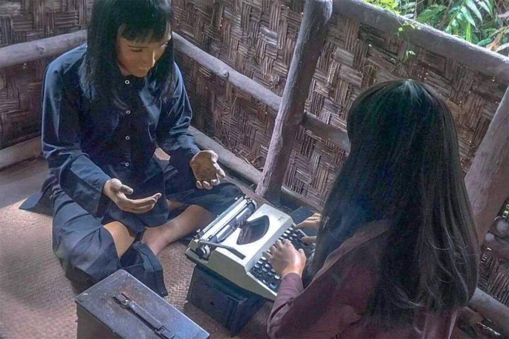 Historical display in Xeo Quyt Forest – Wax figures of Viet Cong soldiers using a typewriter during the Vietnam War.