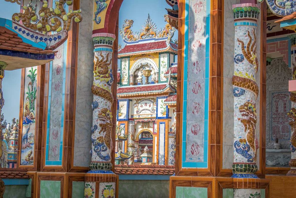 Detailed look at hand-crafted ceramic dragons and tiled columns decorating an ancestral tomb in An Bang Cemetery — an example of exceptional local craftsmanship.