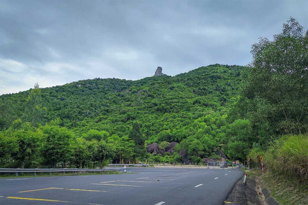 Ca Pass road view with Da Bia Mountain – The winding Deo Ca mountain road with Da Bia Peak visible above the forested hills, a highlight of the scenic drive between Phu Yen and Khanh Hoa.