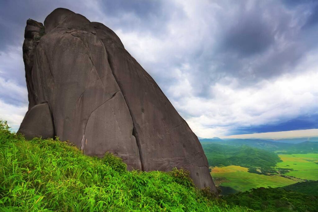 Da Bia Mountain peak above Ca Pass – The giant granite rock of Da Bia Mountain rising dramatically above the green valleys near Ca Pass, a famous hiking and historical landmark in Phu Yen.