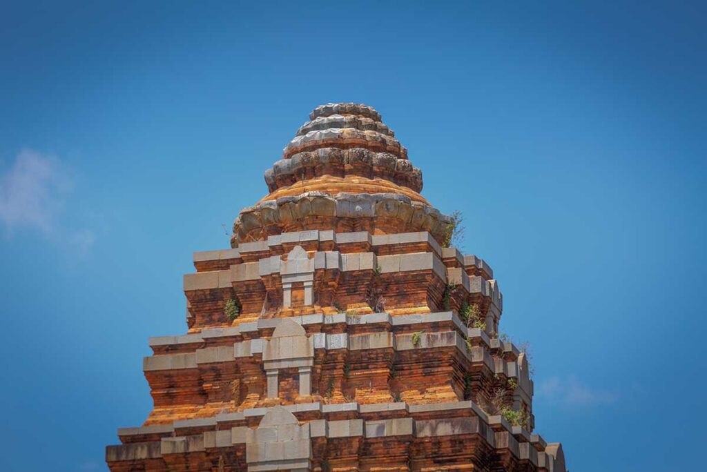 lose-up of the stepped, tiered roof crown of a Duong Long Cham Tower, showing the diminishing levels and lotus-inspired design.