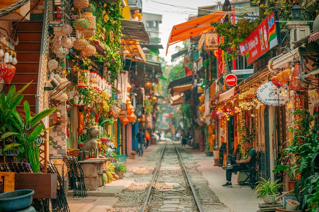 Hanoi Train Street – Local Vietnam tours | colorful cafés and lanterns along the tracks in Hanoi’s famous Old Quarter alley