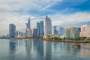 Saigon tours – Local Vietnam | skyline of Ho Chi Minh City with Bitexco Tower and modern riverside buildings seen from the Saigon River