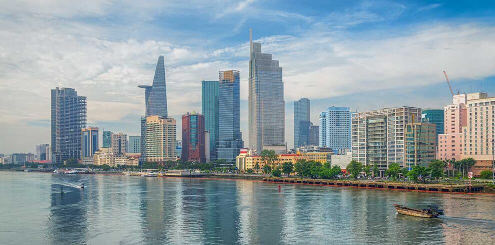 Saigon tours – Local Vietnam | skyline of Ho Chi Minh City with Bitexco Tower and modern riverside buildings seen from the Saigon River