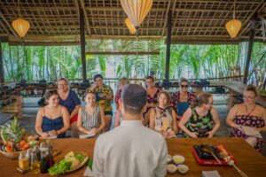 Participants watching a local chef’s demonstration before cooking their own dishes in a Hoi An class.