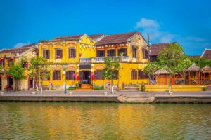 Hoi An Ancient Town – Local Vietnam tours | colorful yellow merchant houses along the Thu Bon River in Hoi An