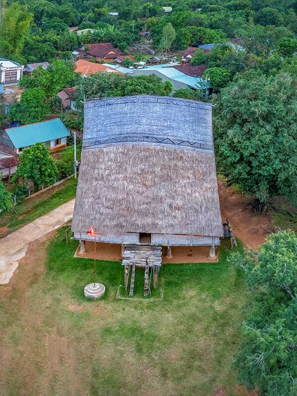 Kon Tum tours – Local Vietnam | aerial view of a traditional Rong house surrounded by ethnic minority villages in Vietnam’s Central Highlands