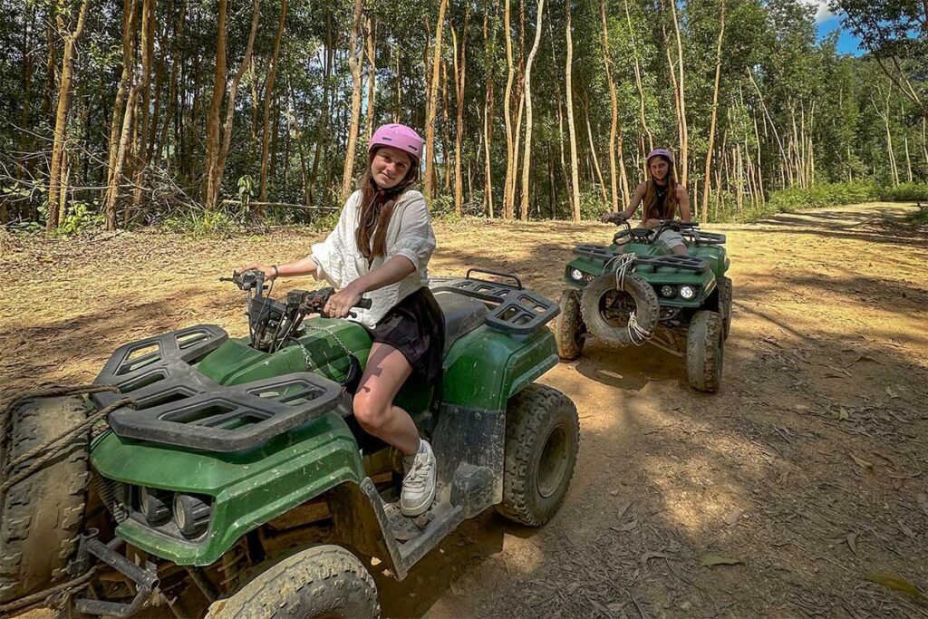 Tourists riding ATVs through the forest trails of Kong Forest Nha Trang, an adventure park inside Hon Ba Nature Reserve.