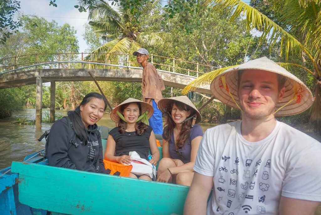 Marnick Schoonderwoerd from Local Vietnam on a boat trip through the canals of the Mekong Delta while exploring local life and tours in southern Vietnam.