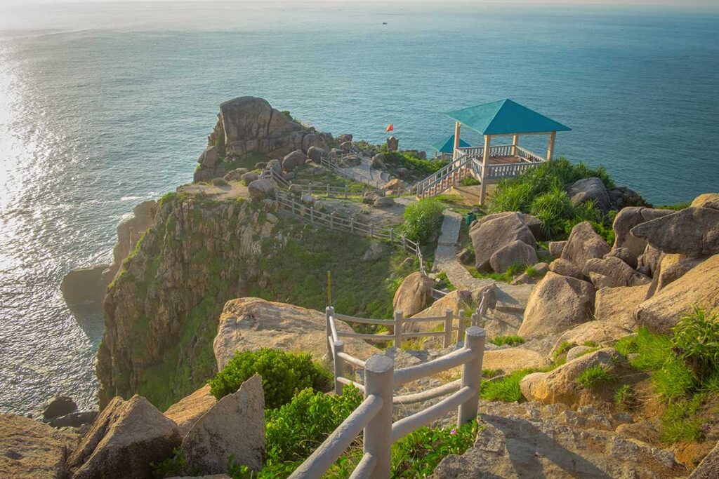 Viewpoint at Mui Dien Cape with rocky cliffs, pavilion, and panoramic ocean views in Phu Yen, Vietnam.