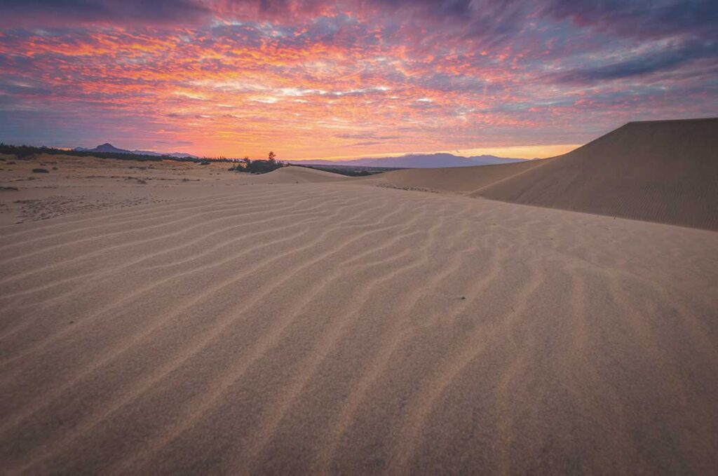Colorful sunset sky over the rippled sand at Nam Cuong Sand Dunes in Ninh Thuan
