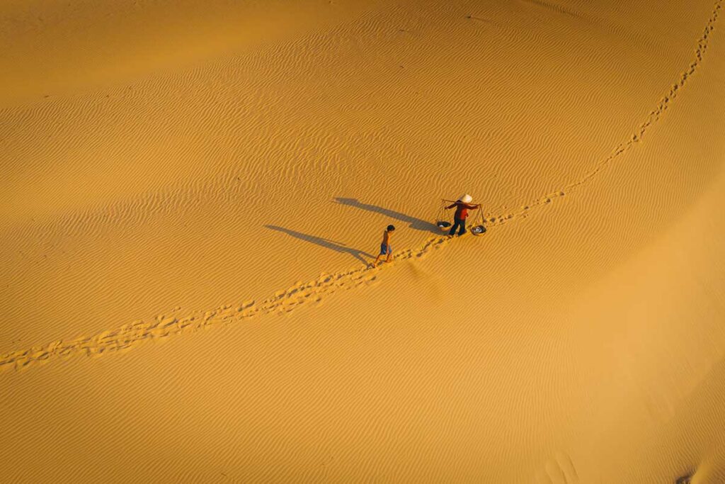 Golden sand patterns and footprints on Nam Cuong Sand Dunes in Phan Rang, Vietnam