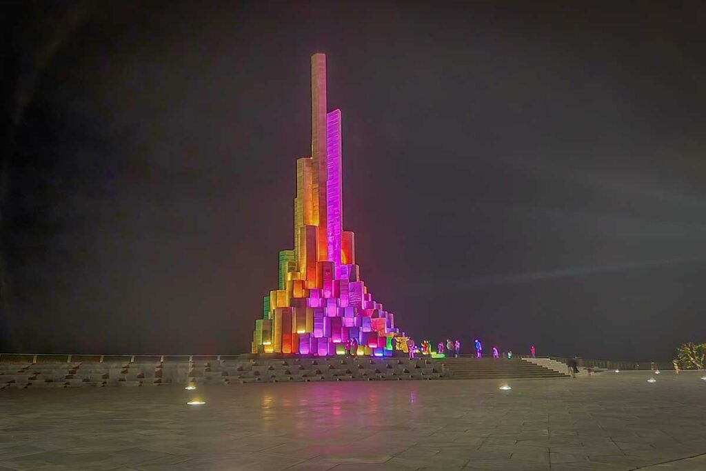 Nghinh Phong Tower illuminated with colorful LED lights and lasers during the evening in Tuy Hoa.