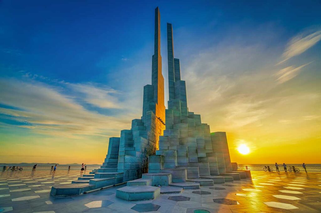 Nghinh Phong Tower glowing in golden light at sunset on the Tuy Hoa coastline, Phu Yen.