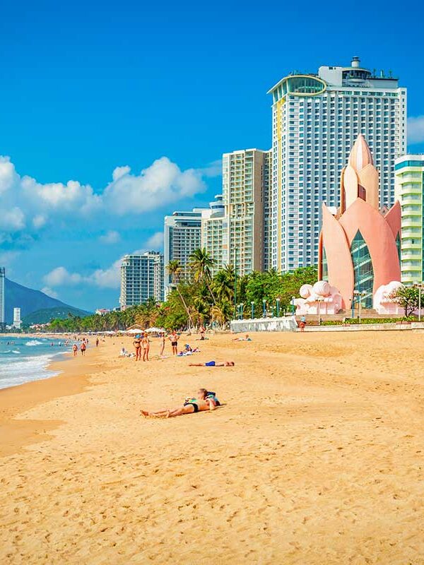 Nha Trang tours – Local Vietnam | view of Nha Trang beach with the Lotus Tower and modern skyline along the coast of central Vietnam