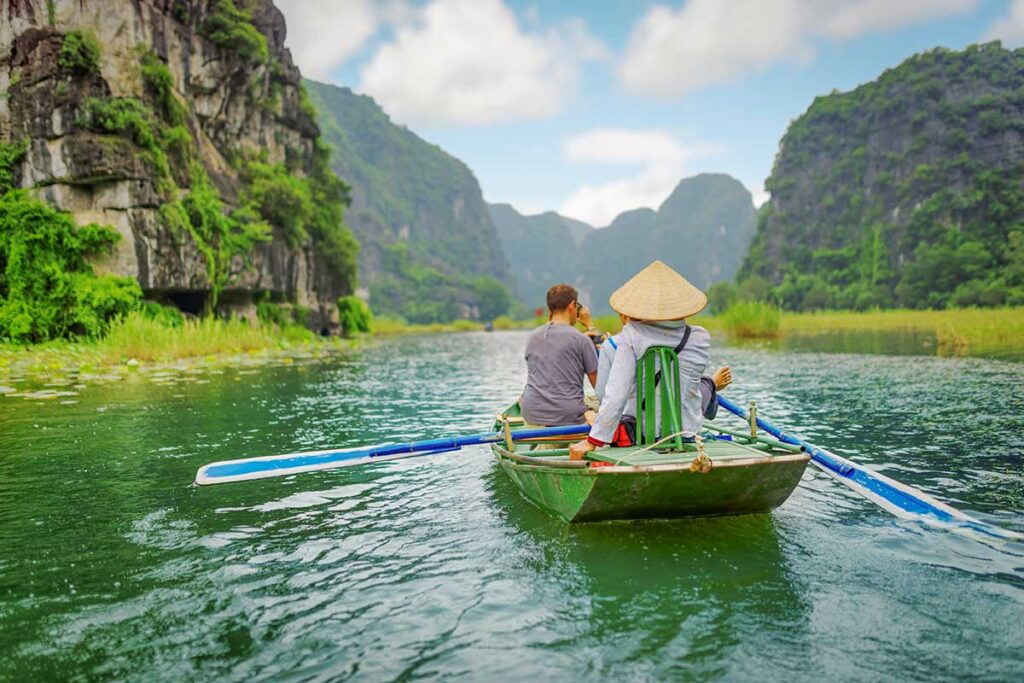 Ninh Binh tours – Local Vietnam | boat ride through river and limestone cliffs in Trang An, northern Vietnam