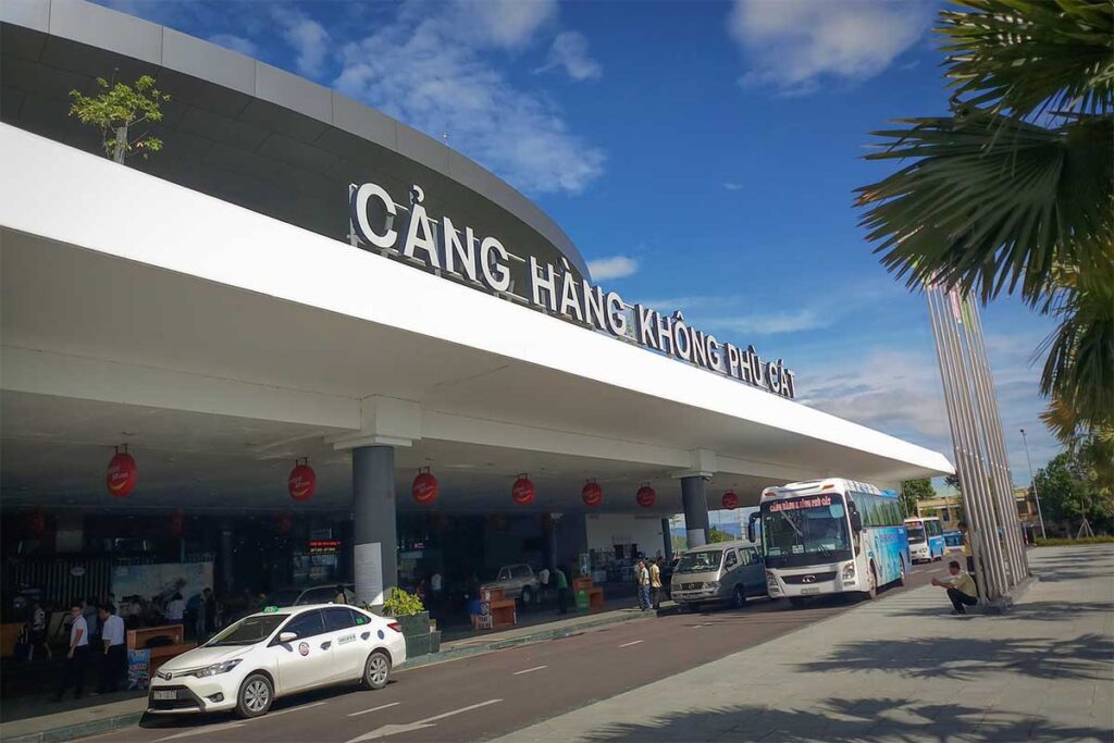 Taxis and shuttle buses waiting outside Phu Cat Airport, the main gateway to Quy Nhon city, offering transfers for the 35 km journey into town.